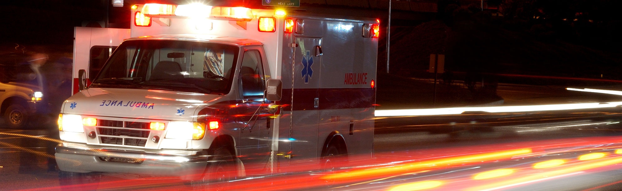 Emergency ambulance racing with lights blazing—ensure your retirement plan covers ground and air ambulance services at 100%