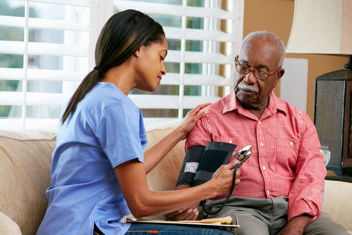 Registered nurse providing in-home health monitoring for retired Alberta educator under extended health benefits