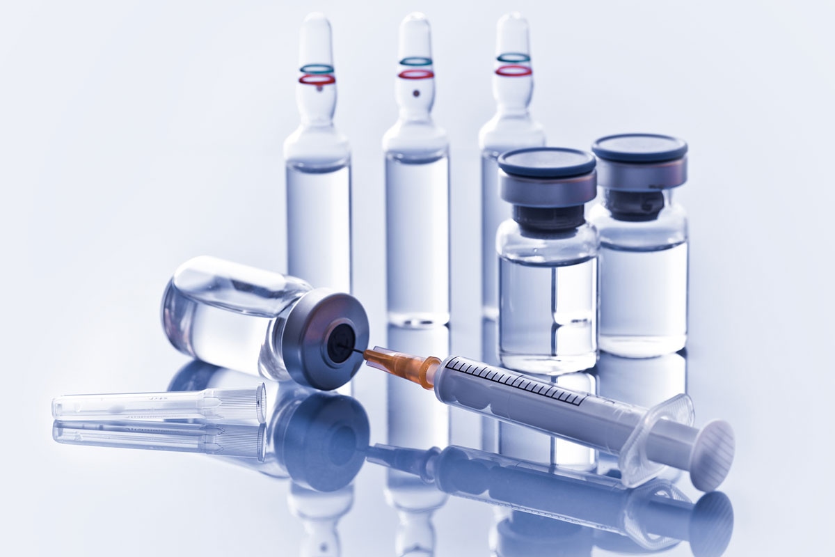 Pharmaceutical vials, ampoules, and syringe representing intravenous supplies covered under ASEBP MyRetiree Plan benefits