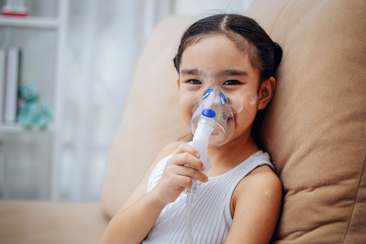 Child using nebulizer mask at home for respiratory treatment covered under ASEBP MyRetiree Plan benefits